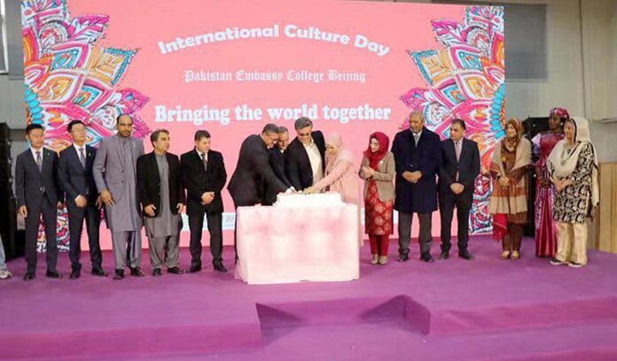 Ambassador of Pakistan to China H.E. Mr. Khalil Hashmi cutting cake to marking a milestone at the 55th anniversary celebration of Pakistan Embassy College, at the International Culture Day hosted by the college