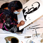 A student gives final touch to the portrait of Allama Muhammad Iqbal on his 147th Birth Anniversary organised by Knowledge Academy ofArts