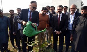 Federal Minister for Planning and Development, Prof. Ahsan Iqbal waters a plant after the foundation stone ceremony of ITU’s new block at Barki Road