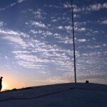 An attractive scene of dense clouds hovering in the sky casts a dramatic shadow that adds depth and mystery to the landscape in the federal capital