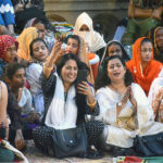 Female visitors enjoying folk music by Pakistan Fisher folk Forum under Fourth Karachi Biennale 2024 at Frere Hall