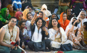 Female visitors enjoying folk music by Pakistan Fisher folk Forum under Fourth Karachi Biennale 2024 at Frere Hall