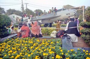 Children having fun on a model fighter plane at Larnas Road
