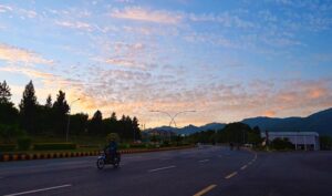 An attractive scene of dense clouds hovering in the sky casts a dramatic shadow that adds depth and mystery to the landscape in the federal capital