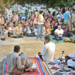 Visitors listening to folk music organized by Pakistan Fisher Folk Forum under Fourth Karachi Biennale 2024 in Frere Hall