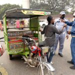 Traffic officials are preventing motorcycle rickshaws from plying on the road at Green Log Doan, Empress Road, Shimla Pahari due to increasing smog