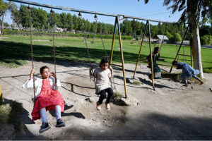 Children enjoy swing at Rani Bagh to spend their holiday on the eve of the birth anniversary of the national poet Allam Muhammad Iqbal