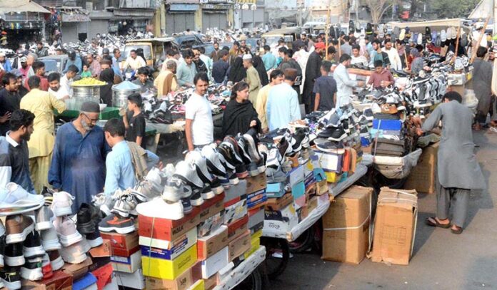 People purchasing used shoes at Sunday Saasta Bazar near Light House