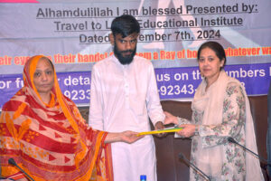 Mrs. Sikandar Hayat, Iram Naz, and Ejaz Ghuree, Executive Member SCCI,distribute white sticks to the blind in a heartfelt gesture of support at the 'Travel to Light Educational Institute' event