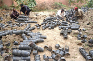 PHA staff prepare small plastic planting pots for new plants at the local nursery on Mall Road, in front of the Commissioner's Office in the provincial capital.