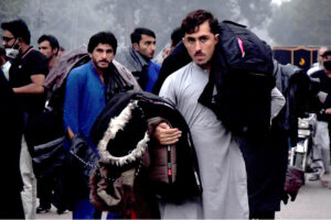 A street vendor sells winter jackets to customers, as demand rises with the dropping temperatures in the provincial capital, while shuttling on the road to earn a livelihood