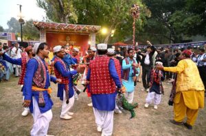 A drumbeater plays while spinning heavy hanging drums around him during the opening ceremony of the 'Annual Ten-Day Folk Festival Lok Mela' at Lok Virsa in the federal capital