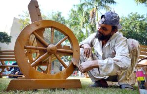 Painters busy painting garden benches at the local garden to enhance its beauty.