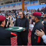 A paratrooper commander presents the national flag to Chief Minister KP, Ali Amin Gandapur, at a horse and cattle show organized by the Directorate General of Sports Khyber Pakhtunkhwa at Col Sher Khan Stadium