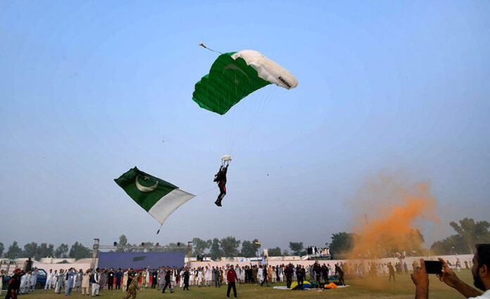 Paratroopers put on an impressive aerial performance during a horse and cattle show organized by the Directorate General of Sports Khyber Pakhtunkhwa at Col Sher Khan Stadium