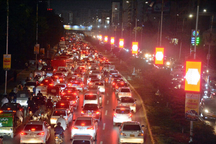 People on their way back to home stuck in traffic congestion at Shara-e-Faisal