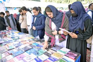 Students keenly viewing books on stall during Book Fair at University of Sargodha