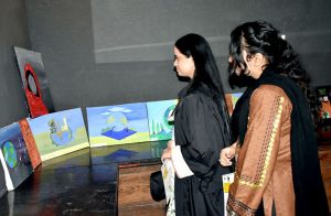 Women visit paintings exhibition express their interest in the beautiful displayed organized The Knowledge of Art Academy.