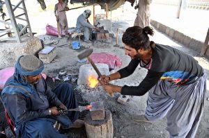 Workers making iron made tools at their workplace at village of Gul Muhammad Khoso.