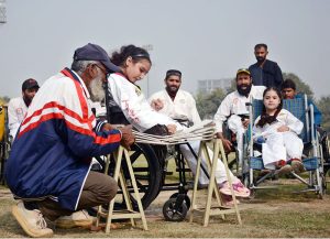 Women are displaying different wool items during the Paralympics Sports Festival to mark the International Day of Persons with Disabilities organized by the Society for Special Persons at Sports Ground.