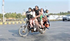 A family of seven dangerously overloaded on a single motorbike, risking their lives