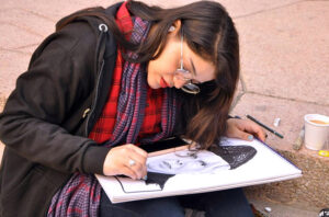 Girl painting a sketch of Quaid-e-Azam Muhammad Ali Jinnah at Alhamra Art Council.