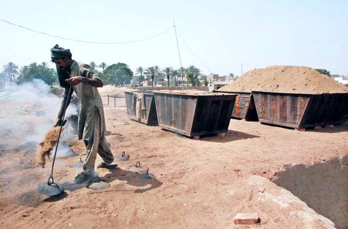 Labourer busy in routine work at local bricks kiln