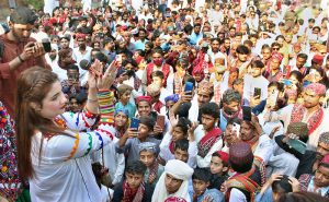 Folk singer performing Sindhi song during celebration of Sindhi Ajrak Topi Culture Day at Sindh Museum