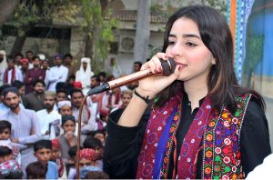 Folk singer performing Sindhi song during celebration of Sindhi Ajrak Topi Culture Day at Sindh Museum