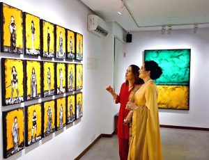 Visitor keenly viewing paintings by artist Nazia Ejaz during an exhibition at Tanzara Gallery