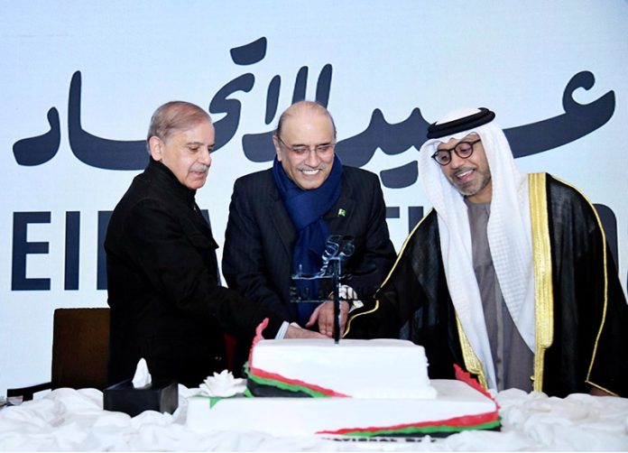 President Asif Ali Zardari, Prime Minister Muhammad Shehbaz Sharif and Ambassador of the United Arab Emirates to Pakistan Hamad Obaid Ibrahim Salem Al-Zaabi cutting cake to mark the National Day of the United Arab Emirates