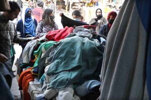 Women busy in selecting and purchasing second hand warm clothes at weekly Sunday Bazaar, Aabpara