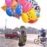 Vendor Displays plastic Balloons to attract customers at Khanna pul