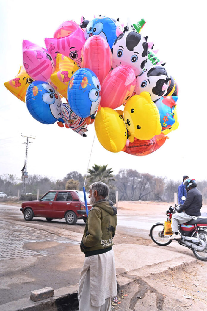 Vendor Displays plastic Balloons to attract customers at Khanna pul