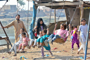 Young girls enjoying the swing at Ghumanabad area.