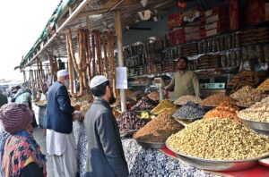 People busy purchasing dry fruits from vendor at H-9 weekly bazaar in the Federal Capital.