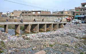 A view of garbage spreading along nullah at Pindorian Bridge is creating environmental problems and needs the attention of the concerned authorities