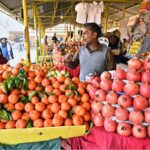 A vendor selling seasonal fruits at stall in weekly Sunday Bazaar Aabpara in Federal Capital
