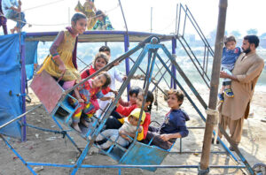 Young girls enjoying the swing at Ghumanabad area.