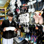 People purchasing second hand shoes at Aabpara in the Federal Capital