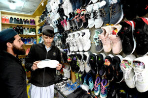 People purchasing second hand shoes at Aabpara in the Federal Capital