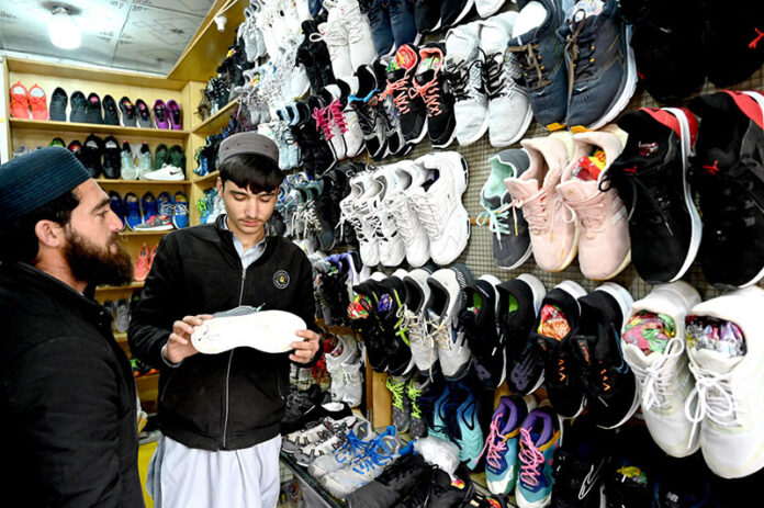 People purchasing second hand shoes at Aabpara in the Federal Capital