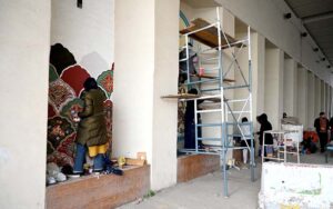 A student creating wall art at Zero Point bridge in the Federal Capital.
