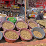 Vendor displaying peanuts to attract the customers at his roadside setup in the Federal Capital