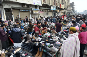 People busy selecting and purchasing second-hand clothes from the vendors at Ganj Mandi.