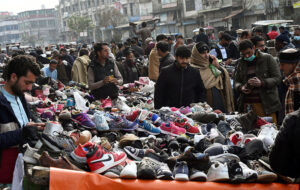 People busy selecting and purchasing second-hand clothes from the vendors at Ganj Mandi.