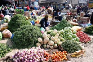 Vendor displaying fresh vegetables to attract customers at Sabzi Mandi.