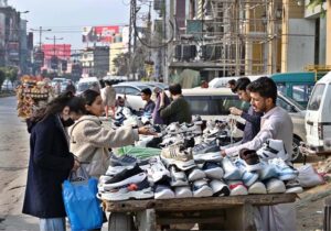 Vendors selling shoes at their roadside setup in Commercial Market