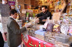 Customer selecting and purchasing different dry fruits from vendor at Sadar bazar.