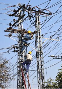 WAPDA staffers busy in maintenance work electricity wires on electric pole near Stadium Road.